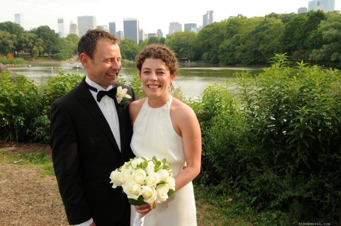 Bride and groom laughing in front of the lake by: Steve Worth